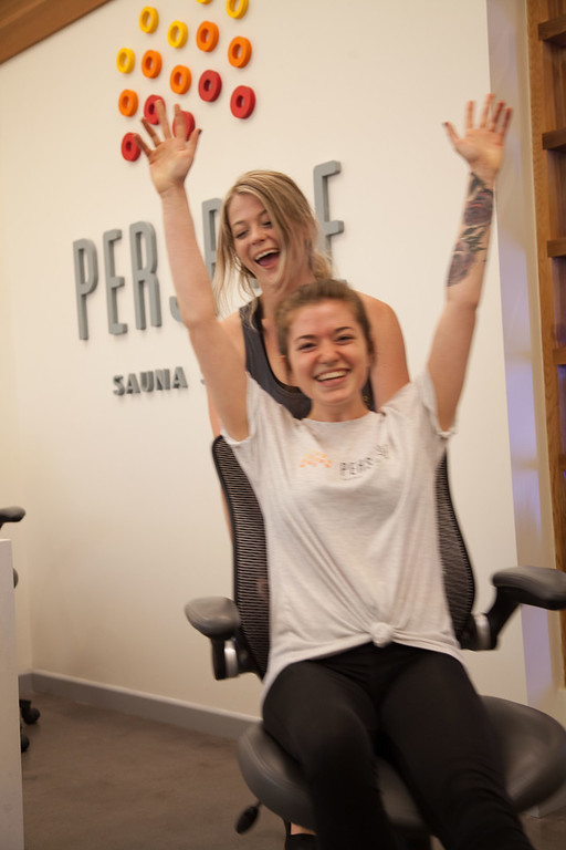 Perspire Sauna Studio employees holding sign